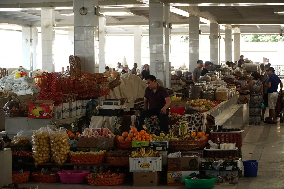Fruit, dried fruit and goods stacked on stalls inside the covered Siyob Bazaar in Samarkand